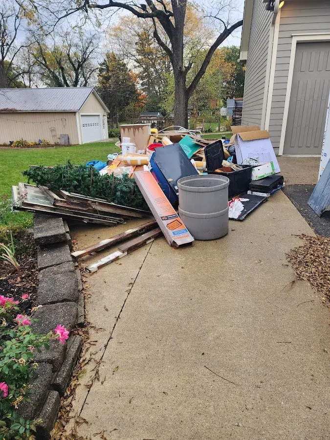 Dumpster being loaded with debris for 12 Yard Dumpster Rental in Manchester